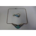 A silver and enamel decorated pendant on silver necklace and similar brooch, approx 0.5 troy oz,