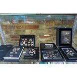 Five Royal Mint British proof sets including Royal Shield of Arms, all good condition