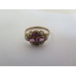 A 9ct ring set amethyst and seed pearls, size Q, approx 1.7 grams, has been resized