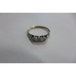 A 9ct gold three stone diamond illusion set ring, size M, approx 1.4 grams