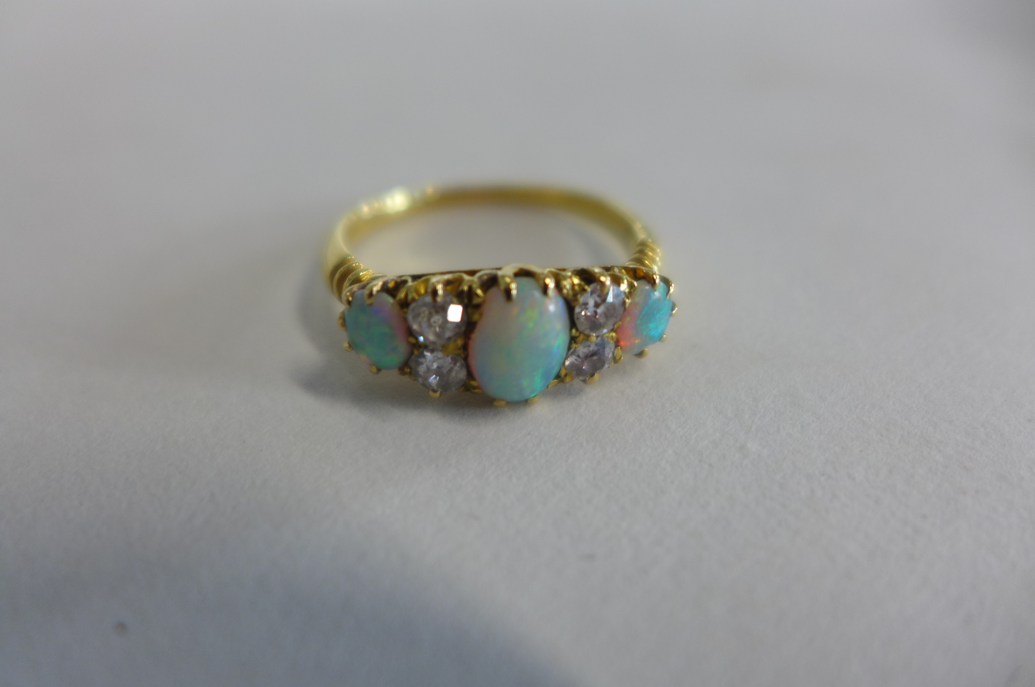 A yellow gold opal and diamond ring, tests to approx 18ct, ring size N, approx 3.2 grams, opals