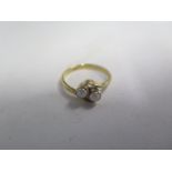 An 18ct gold two stone crossover ring, size N, approx 3.1 grams