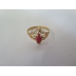 An 18ct gold ring with pierced setting and central coral stone, size I, approx 2.7 grams - in good