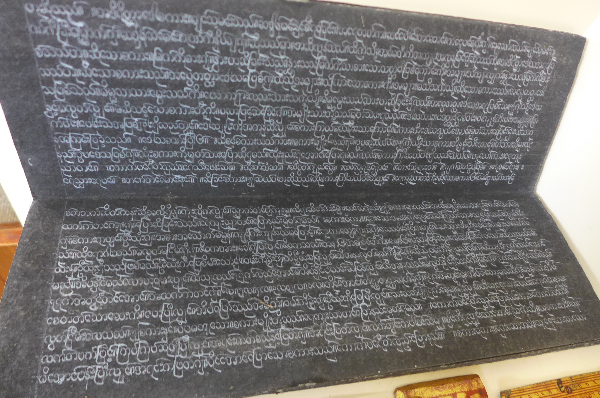 A collection of Tibetan prayer scripts, including a carved block - 15cm long - Image 5 of 6