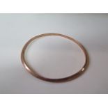 A 9ct gold bangle, 8cm diameter, approx 5 grams, some small denting, otherwise generally good