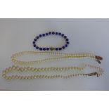 A pearl necklace with 9ct claasp, a pearl necklace with yellow metal clasp together with a lapis
