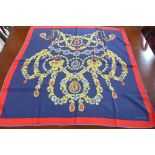 A Must de Cartier silk scarf with jewellery design upon blue ground, approx 84cm x 87cm in good