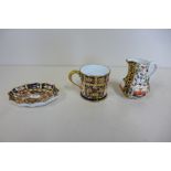 A Royal Crown Derby miniature tankard and dish and a S and H Derby miniature jug, 15cm tall, all