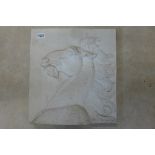 A composition stone plaque worked in high relief and decorated with the head of a mythical horse,