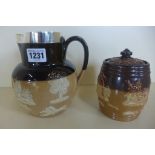 A silver rimmed Doulton jug, London hallmark and a jar, both generally good