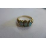 A 9ct gold three stone opal ring, size Q, approx 3.3 grams, some usage marks