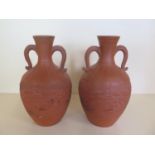 A pair of Japanese terracotta dragon twin handled vases, 25cm tall, both generally good, minor