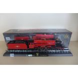 A Hogwarts Express die-cast train model and base, boxed
