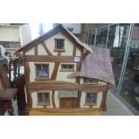 An unusual cottage dolls house with furniture and dolls, designed and built by Val Long 1997 -