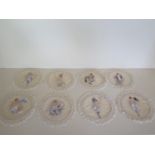 A boxed collection of eight late 19th century French silk mats each approx 17cm diameter silk with