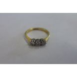 An 18ct gold and platinum three stone diamond ring, size L, approx 2.3 grams