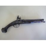 An 18th century flint lock pistol with engraved part octagonal barrel, with two gilt metal marks,