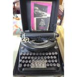 A portable Remington Noiseless typewriter, with case and typewriting manual
