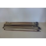 A collection of seven assorted violin bows and a cello bow, none are named