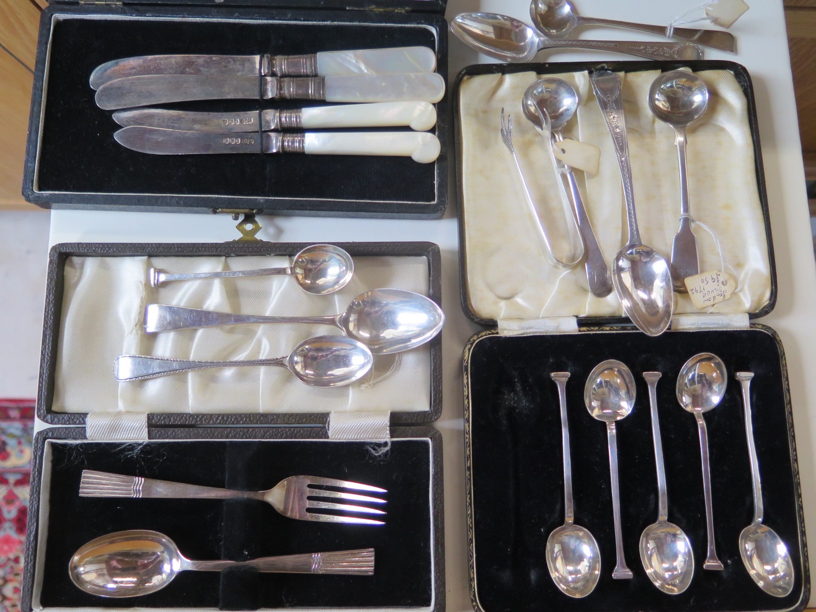 Eight pieces of silver flatware, and a cased set of six spoons, knife and fork and two silver bladed