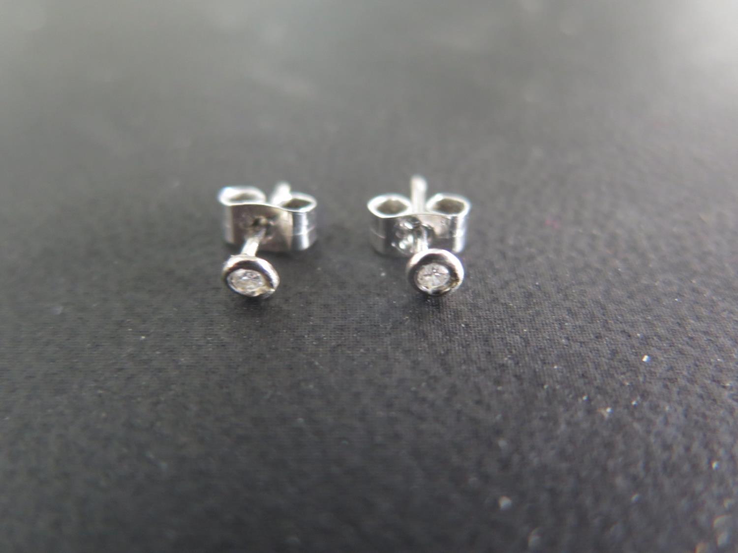 A pair of 9ct gold diamond stud earrings