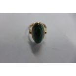 A 9ct gold dress ring with green oval stone, size H, approx 5.2 grams