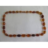 An amber necklace, approx 65cm long, approx 39 grams, overall in good condition but with some