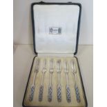 A set of six silver cake forks with enamel decoration by Liberty and Co, in original Liberty