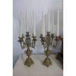 Two brass five branch candelabra garnitures with candles, 66cm tall