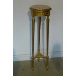 A gilt jardiniere stand with a marble top, 116cm tall, 31cm diameter