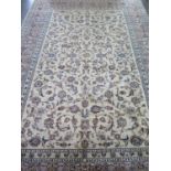 A hand knotted woollen Kashan rug, approx 305cm x 203cm - in good condition