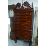 An American style mahogany chest on stand with an arrangement of nine drawers, 211cm tall x 90cm