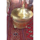 An early 19th century brass log bin, 52cm tall x 41cm wide