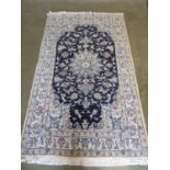 A hand knotted woollen Nain rug, approx 203cm x 117cm - in good condition