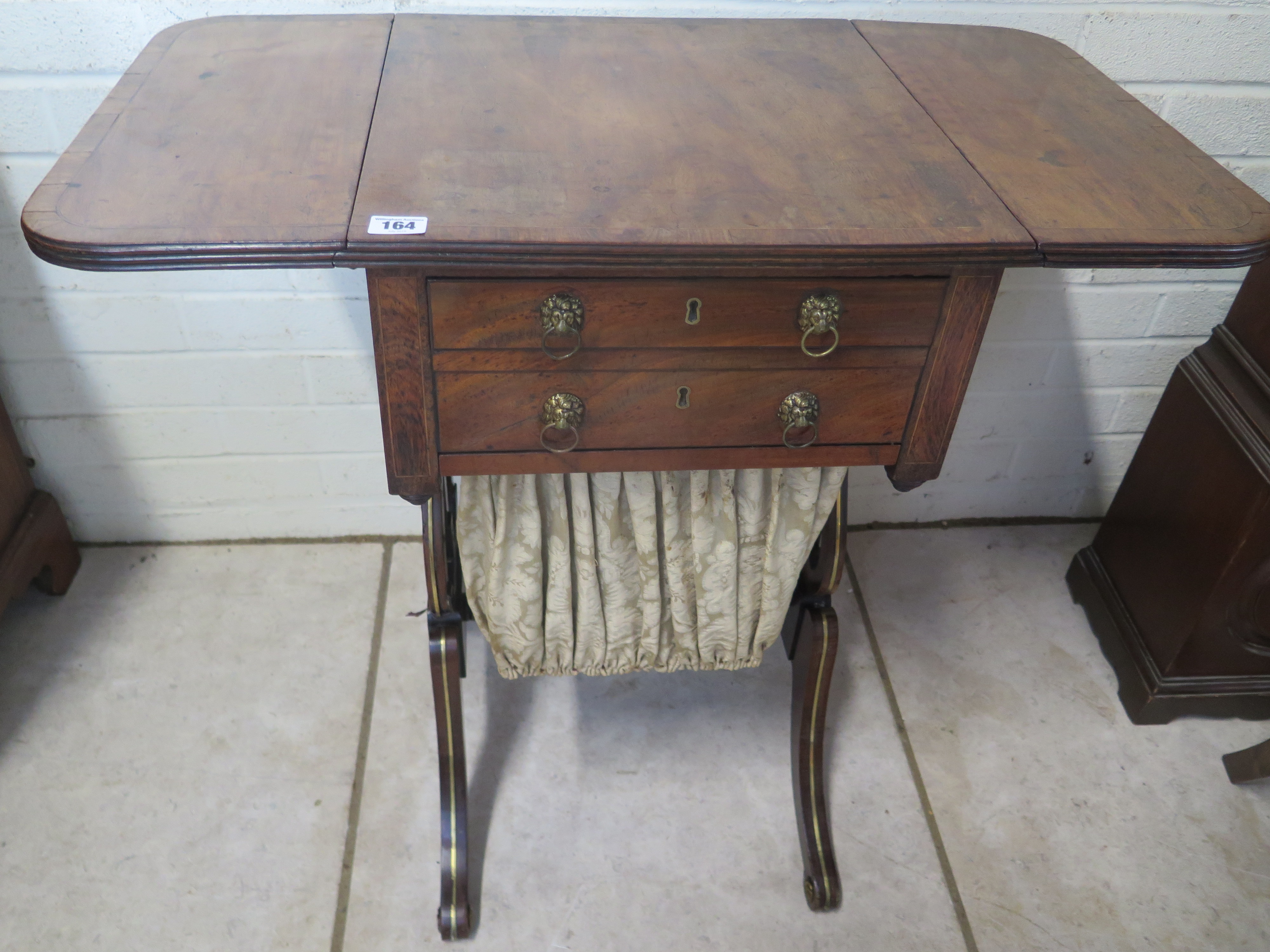 A 19th century mahogany and cross banded work box, with drop flaps, two drawers and a pull out