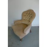 A Victorian button back fireside chair