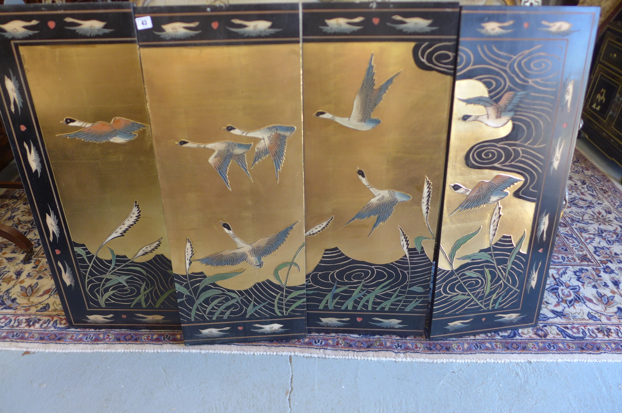 An oriental four section panel wall screen decorated with birds, 92cm tall x 124cm wide in total