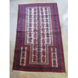 A hand knotted woolen Old Baluchi rug - approx 147cm x 89cm - in good condition