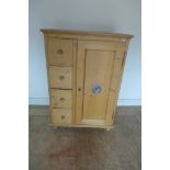 A continental pine food cupboard with four drawers to one side and a single door to the other -