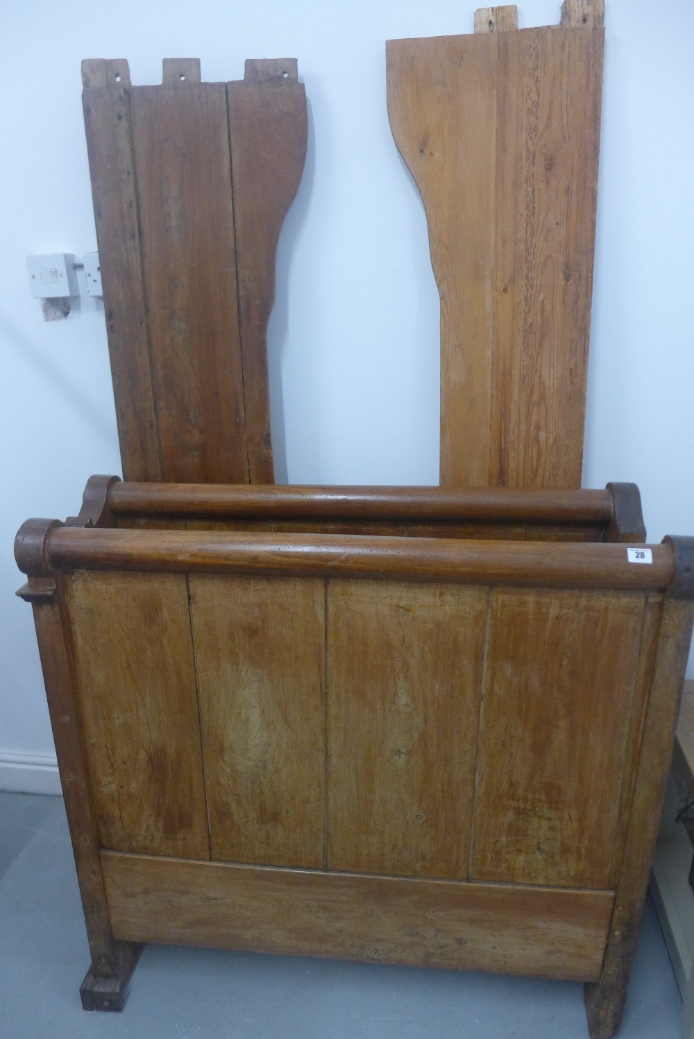 A 19th century continental sleigh bed 101 cm tall, 101cm wide, 203cm long, with slatted base