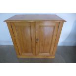 A Victorian pine two door cupboard, with varnished finish, 88cm tall x 91cm x 48cm