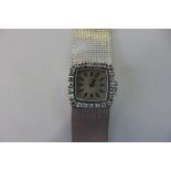 A ladies vintage 18ct white gold Omega diamond encrusted manual wind wristwatch, the square dial
