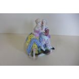 A Meissen group of gallant and companion embracing, 15cm tall - good condition