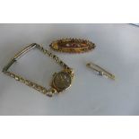 A 15ct gold brooch, approx 4.4 grams, a 9ct brooch approx 1.3 grams, and a 9ct gold ladies watch