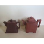 Two rectangular form Chinese red ware teapots both decorated with Chinese characters, largest approx