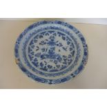 A Delft blue and white dish, 30cm diameter with chips and losses to rim and old repairs