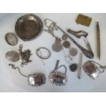 An assortment of silver and white metal items including wine labels, coins, pen etc, total weight