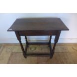 An 18th century and later oak side table on turned supports, 69cm tall, 74cm x 38cm