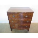 A 19th century mahogany bow fronted four drawer chest of small proportions on splayed bracket