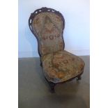 A well carved 19th century walnut fireside upholstered chair on scroll legs and brass casters, in